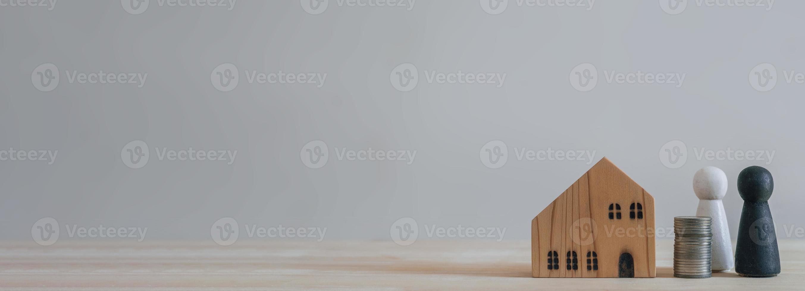 New home concept ,happy couple planning new home, house model and people model on wooden table photo