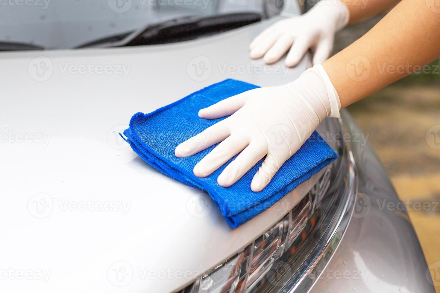 Car care workers cleaning the car photo