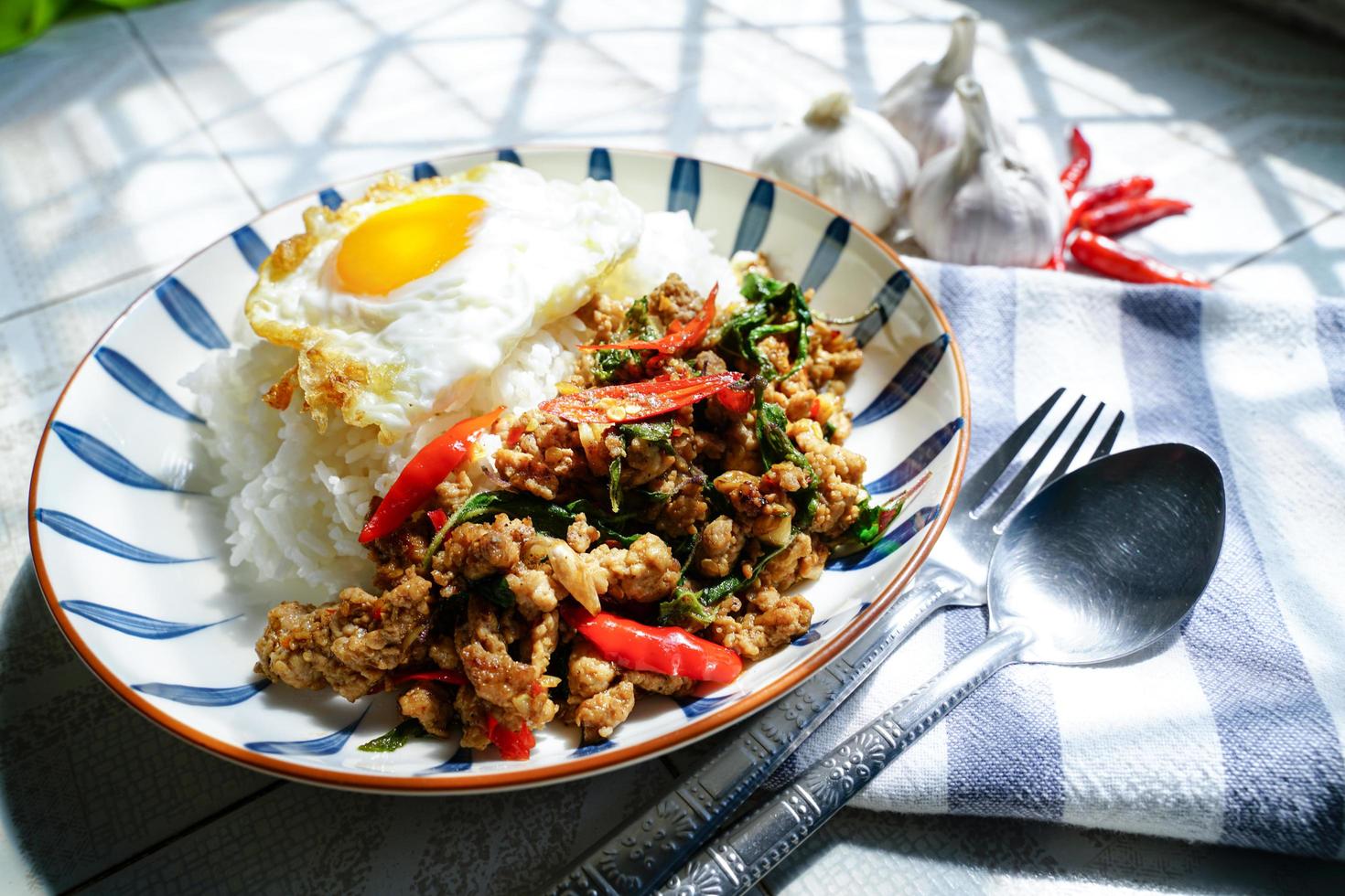 Stir Fried Basil with Minced Pork and Fried Egg is a popular dish because it's quick and easy to make.  spicy taste photo