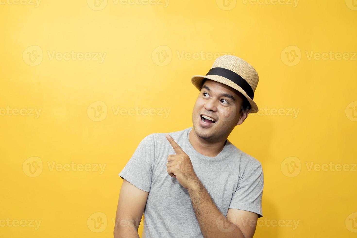 A handsome man in a good mood standing in the yellow background photo