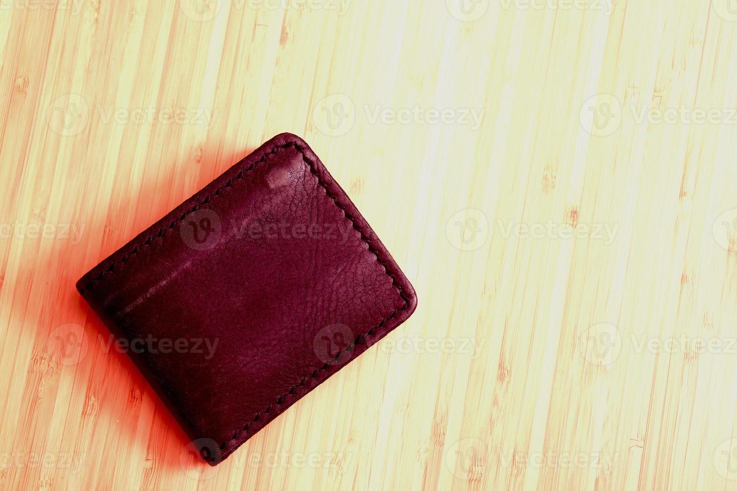 New black genuine leather wallet with banknotes. photo