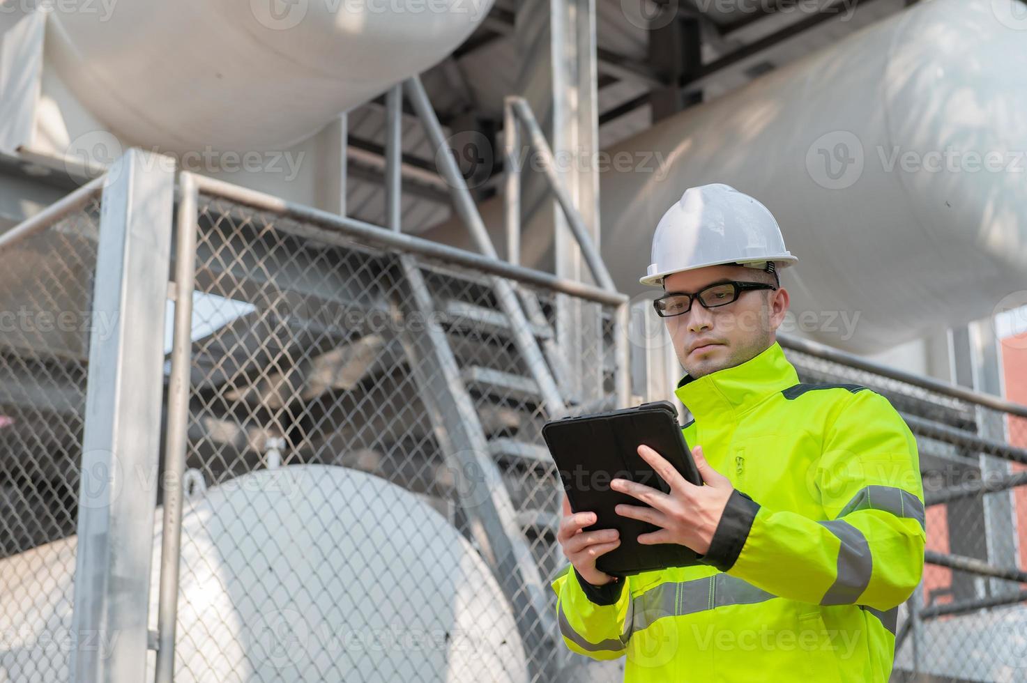 Engineers work place to keep liquid helium,preventive maintenance schedule checking,Thailand people,Technicians and engineers discuss work together. photo