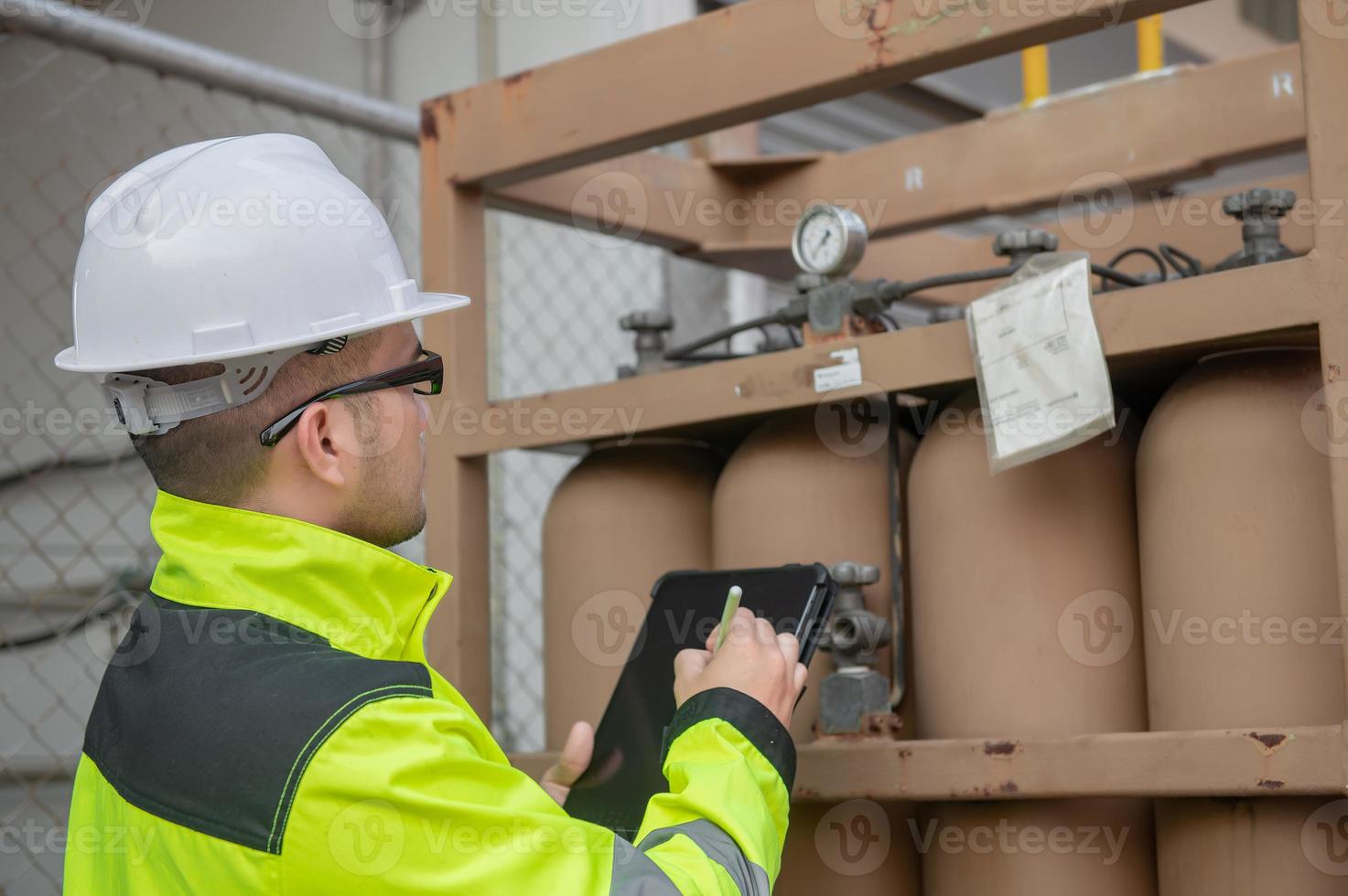Engineers work place to keep liquid helium,preventive maintenance schedule checking,Thailand people,Technicians and engineers discuss work together. photo
