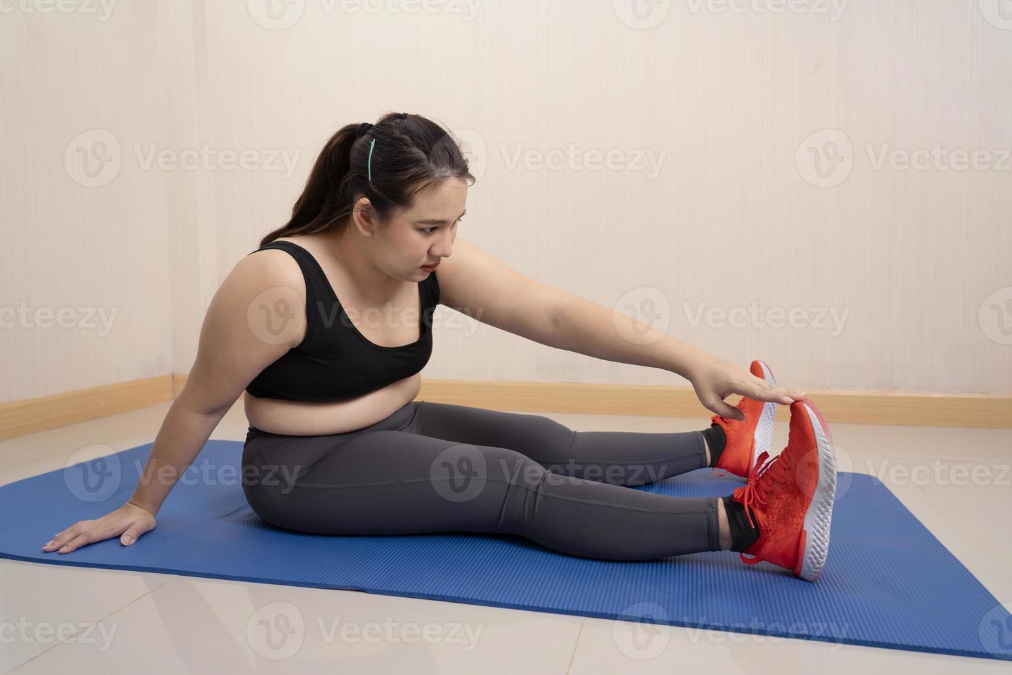 Beautiful fat woman in sits stretching on the before exercising at home. Dedicated to fitness. Sports motivation, concept, training endurance, Healthy weight loss, overweight 13095156 Stock Photo at Vecteezy