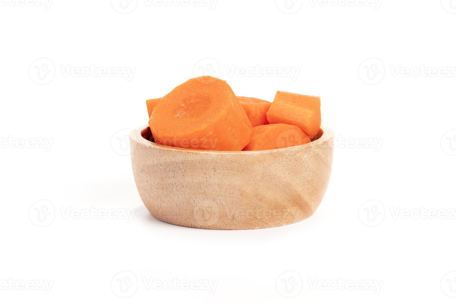 carrot slices in a wooden cup isolated on white background. fresh carrots in a wooden cup. cooking ingredients photo