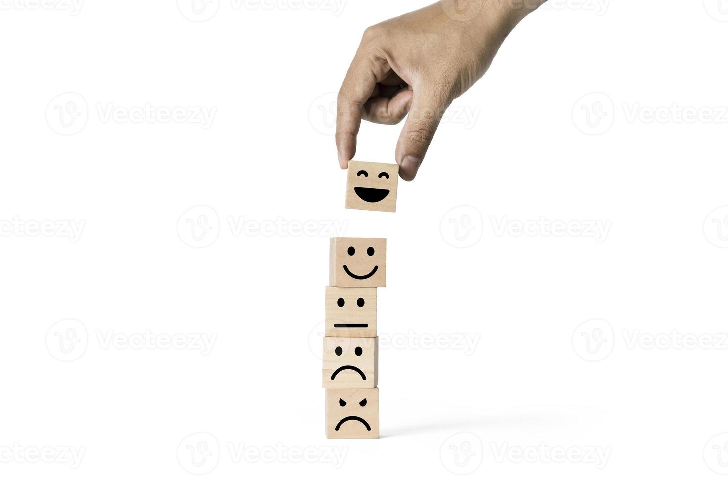 Hand holding smile face symbol on wooden cube blocks Best service rating, Customer service evaluation and satisfaction survey concepts. Service rating, ranking, customer review photo