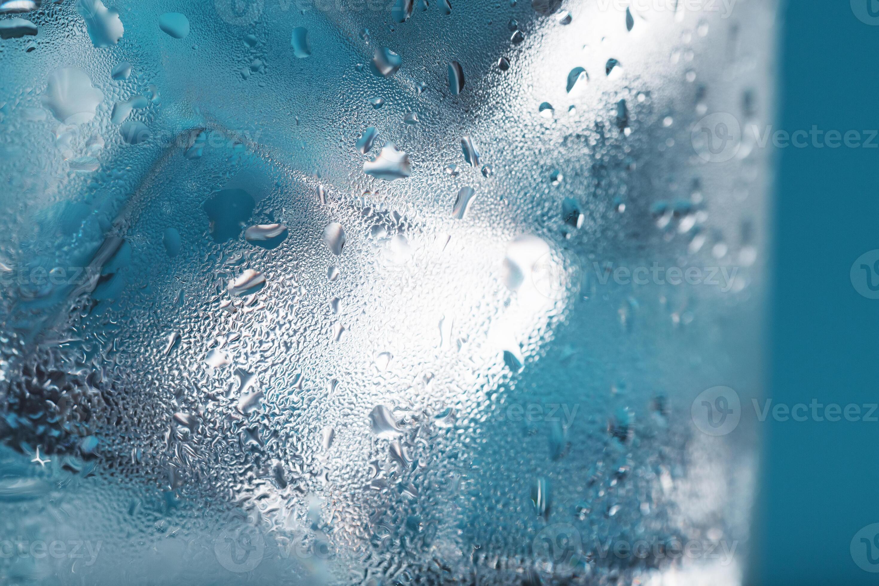 Ice cubes in a misted glass with drops of ice water closeup macro