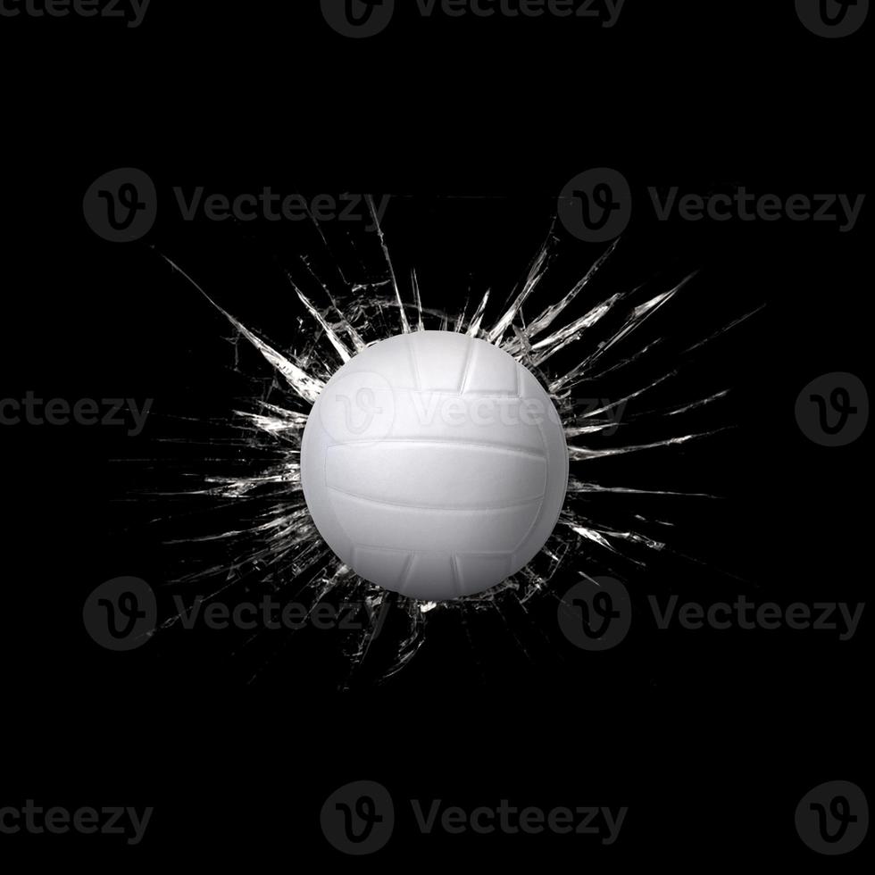 Fast volleyball through broken glass on black background photo