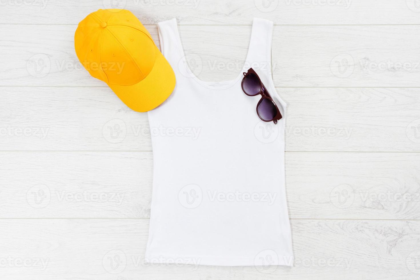 White closeup t shirt mock up flat lay on white wooden background. Top view and copy space. Mockup summer t-shirt and summertime. Template blank shirt. photo