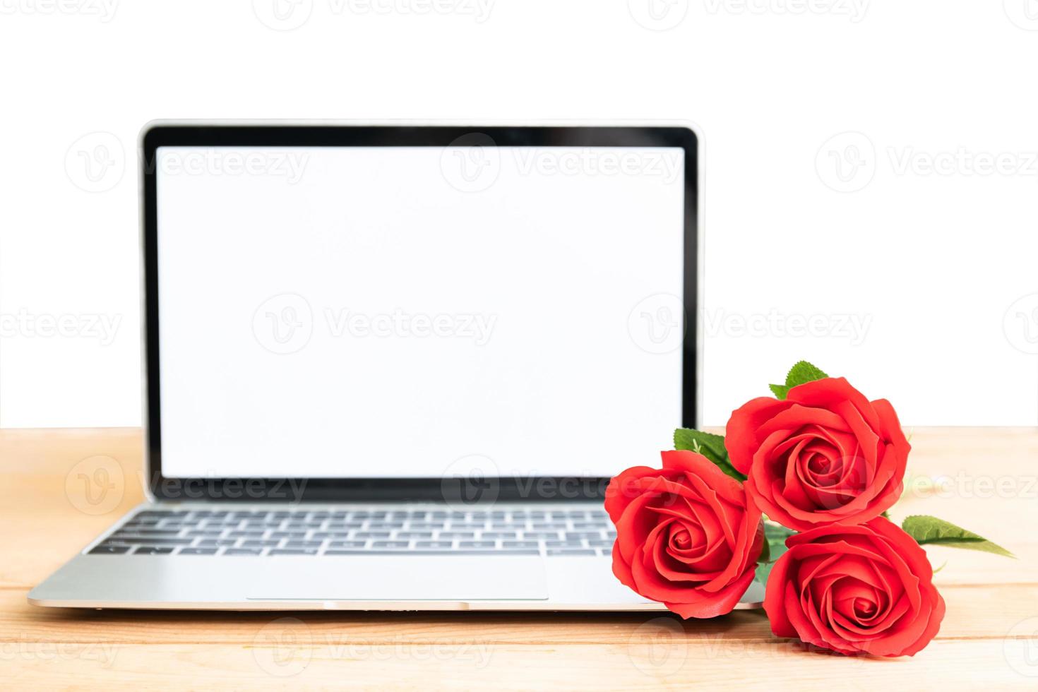 Red rose and laptop mockup on white photo