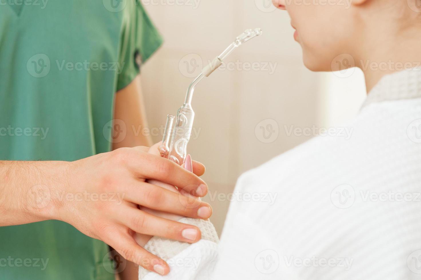 Woman receives nasal inhalation. photo