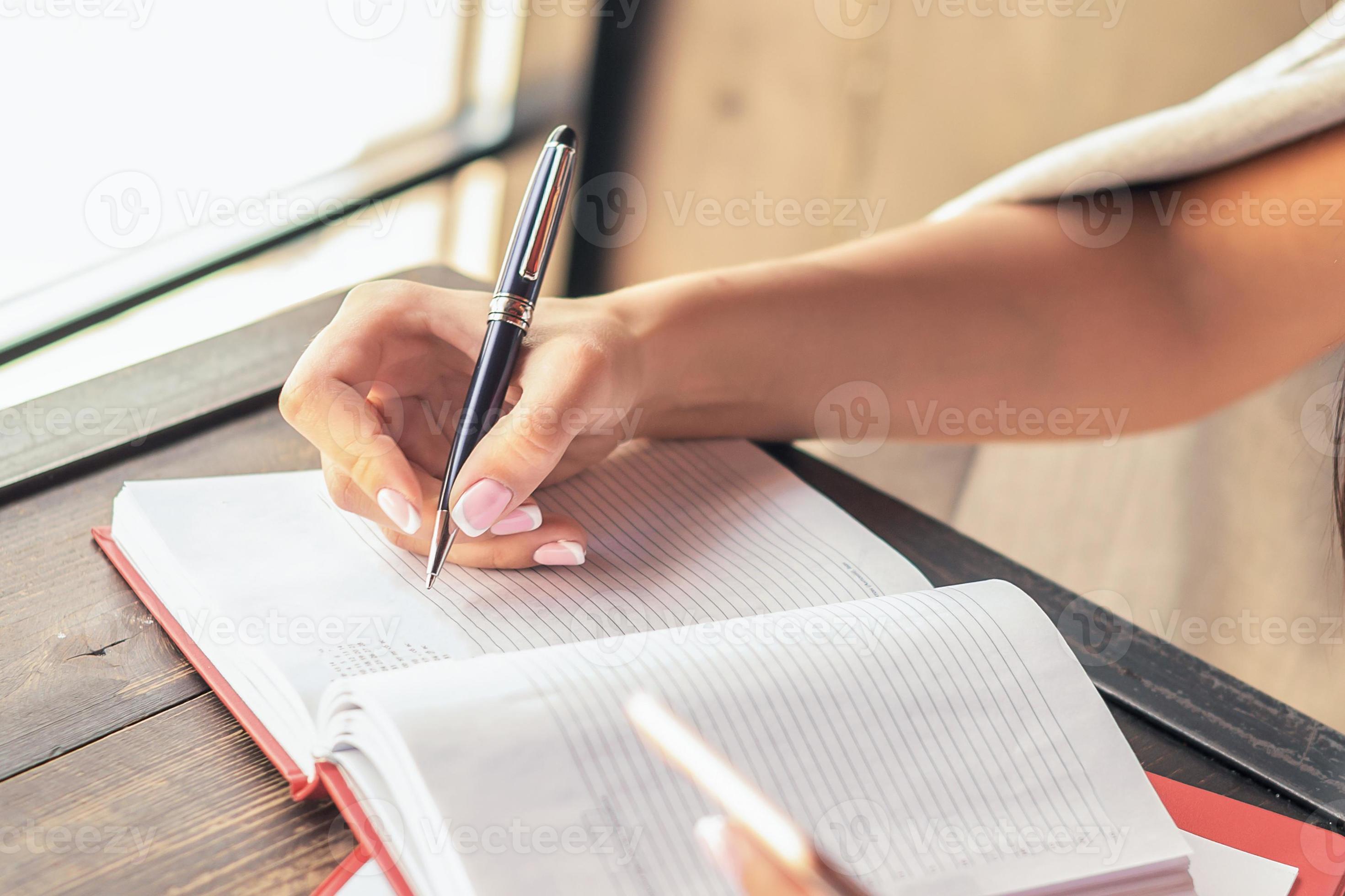 Woman writing in notepad. 13098520 Stock Photo at Vecteezy