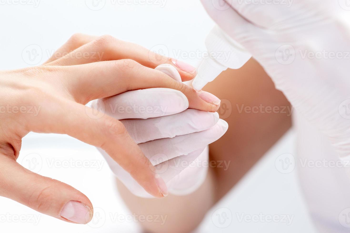 Manicurist uses manicure tool. photo