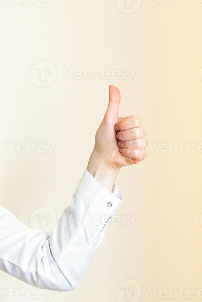 Hand of woman showing thumb up photo