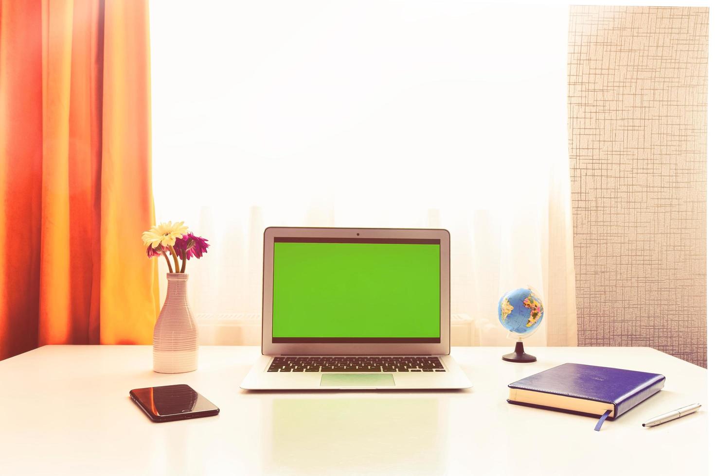 Mock up white laptop computer empty screen on table in modern creative design home room, office space or modern cafe interior with mood board. Mockup notebook blank monitor for ads front view photo