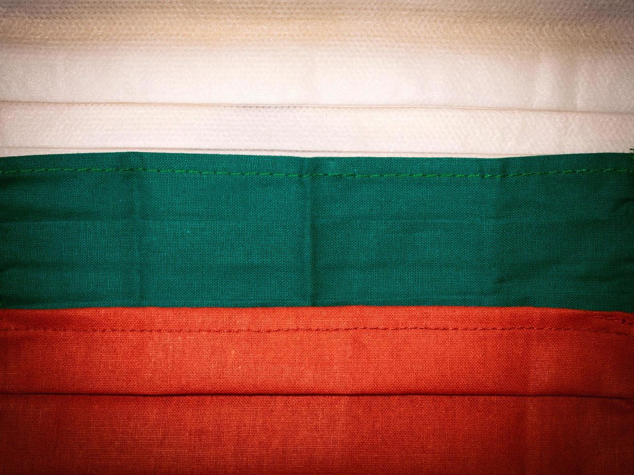 Medical facial masks close up formed Bulgarian flag. Concept of Corona virus outbreak in BULGARIA. photo