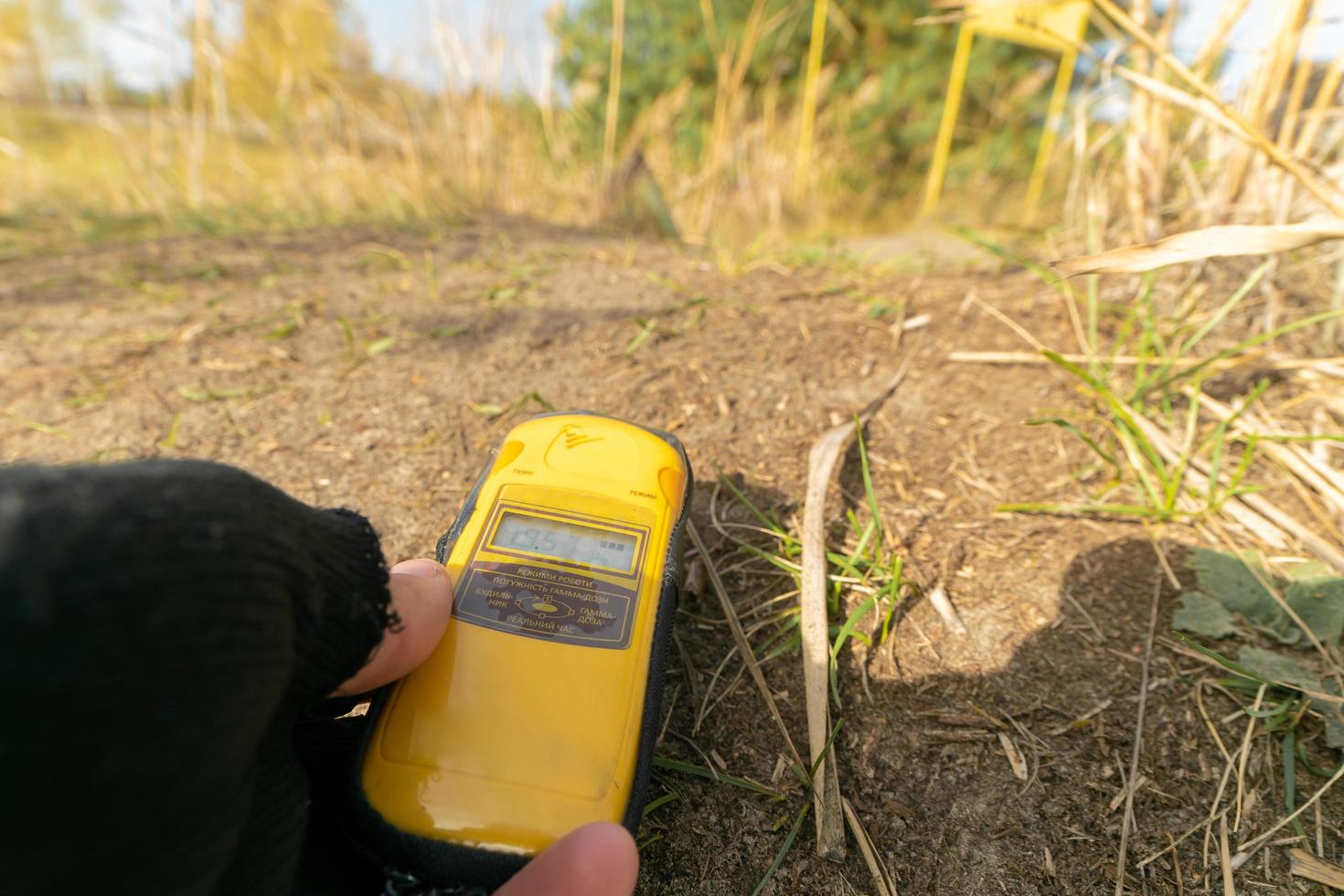 dosimeter in hands in radioactive area photo