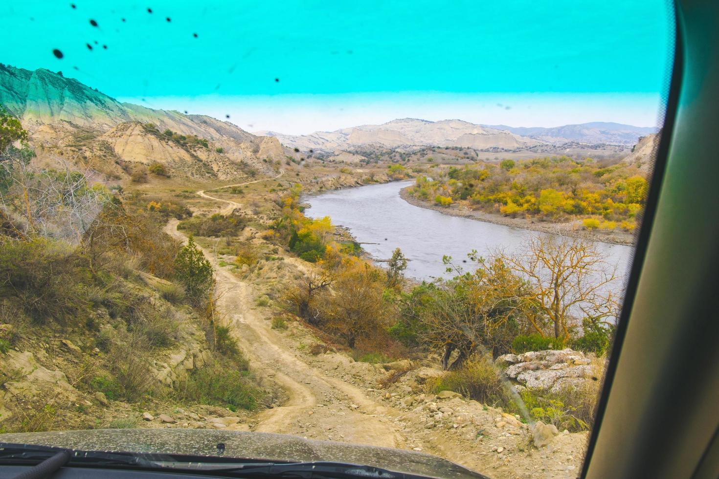 vista de pasajeros desde la ventana del camino de grava y el río en las áreas protegidas de vashlovani. viajes en 4x4 georgia foto