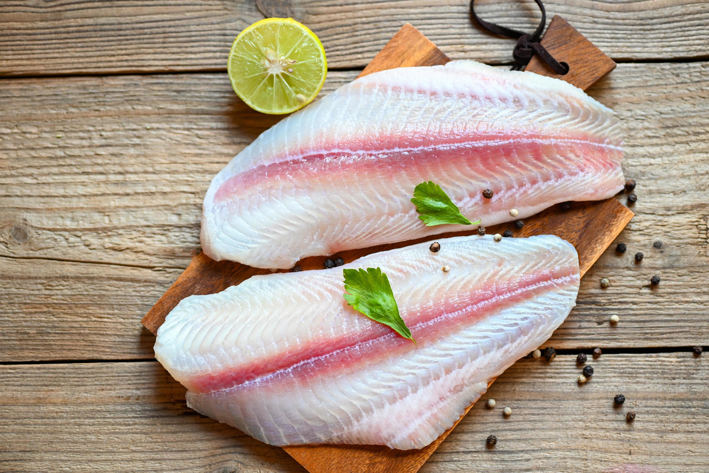 Meat dolly fish tilapia striped catfish, fish fillet on wooden board