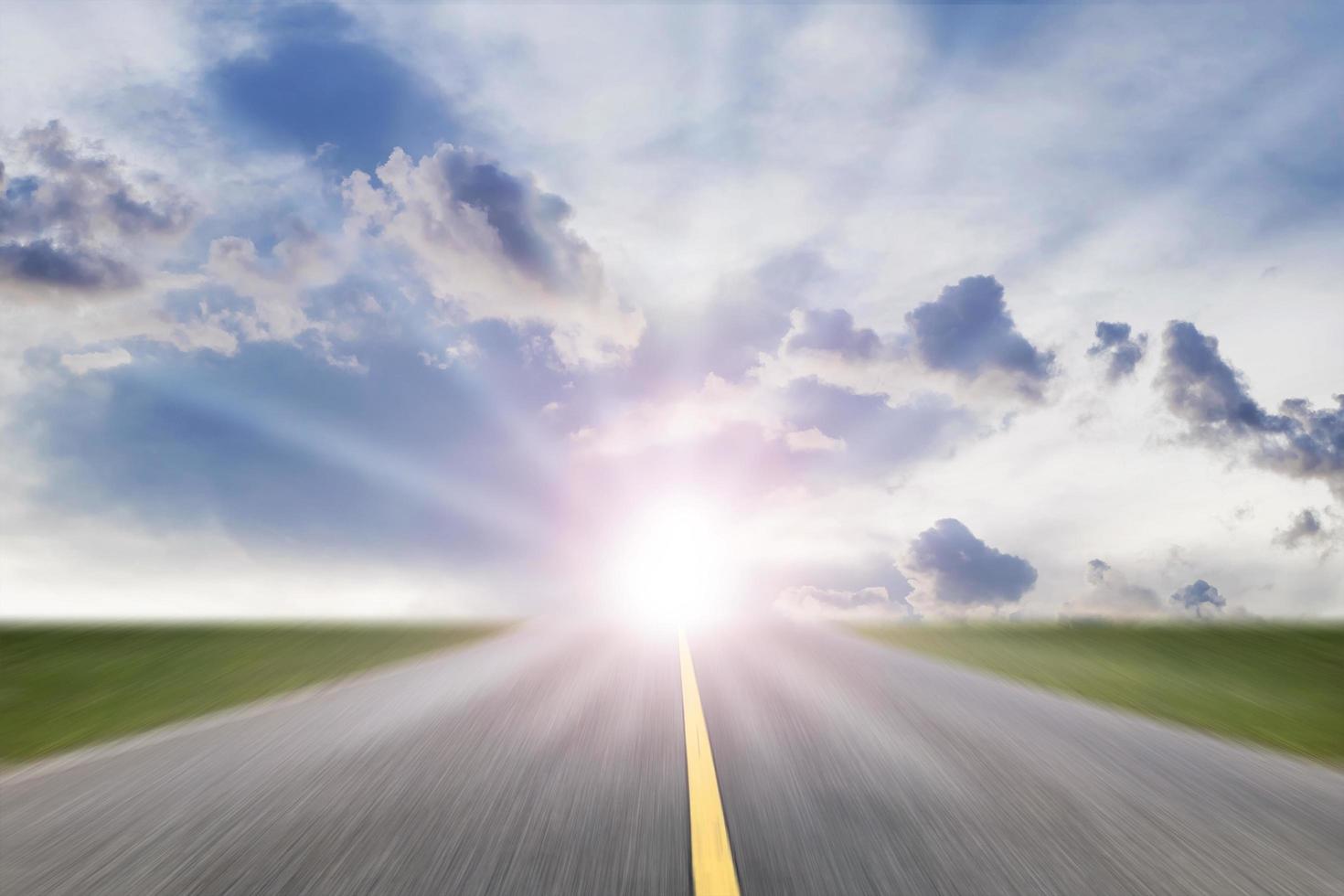 Motion blur of driving on way with sunset,Dawn on the road with rural scene, Green field and route over blue sky ,Moving on the highway,Country road at the sunrise photo