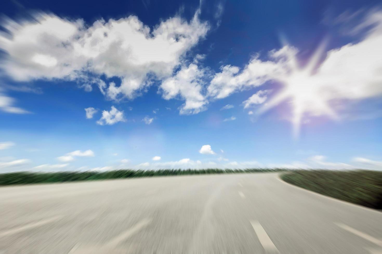 Motion blur of driving on way with sunset,Dawn on the road with rural scene, Green field and route over blue sky ,Moving on the highway,Country road at the sunrise photo