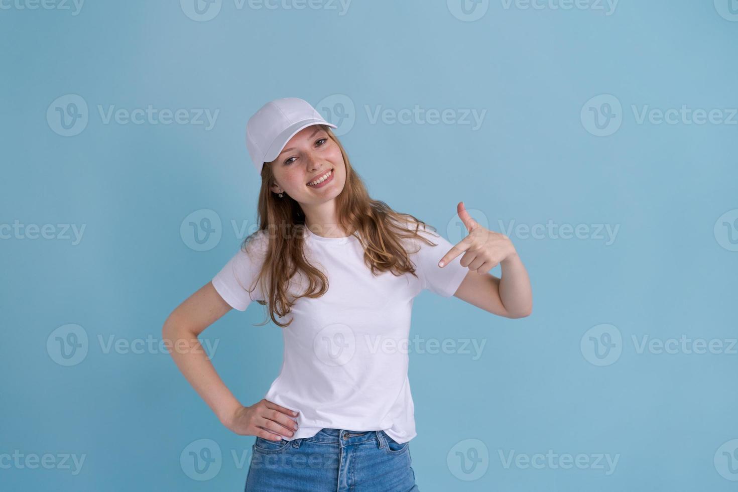 Young caucasian happy girl in delivery uniform and white cap looks confident photo