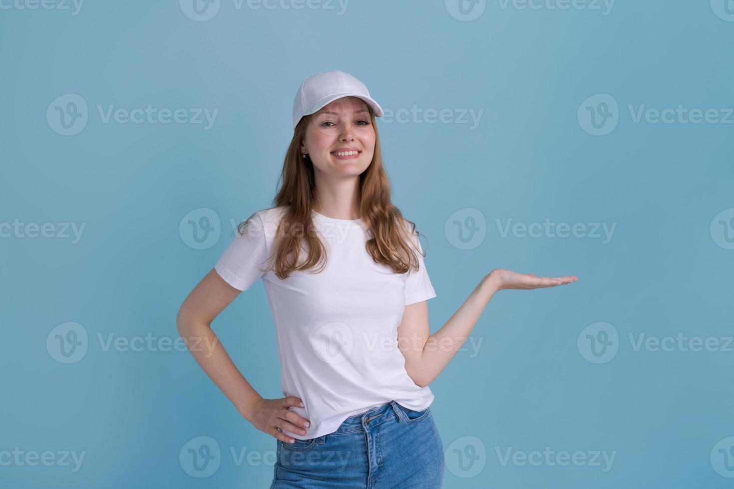 Great promo. Happy beautiful woman pointing aside at copy space with hand photo