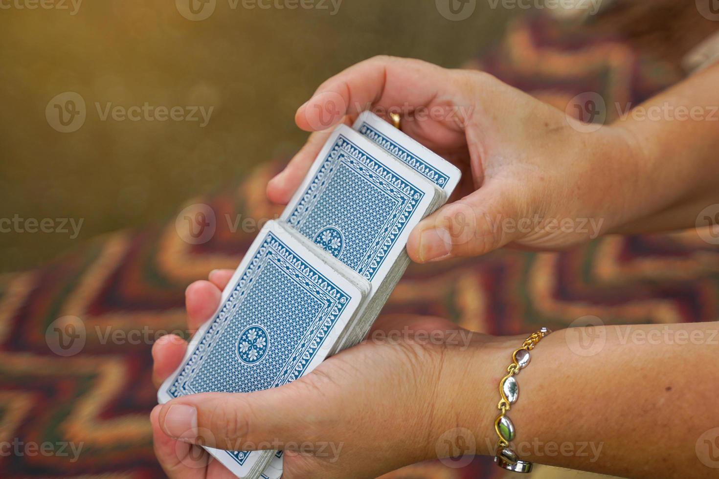 Close-up shot of the dealer's shuffling to clear the cards before the next play, concept Family leisure activities or camping. Soft and selective focus. photo
