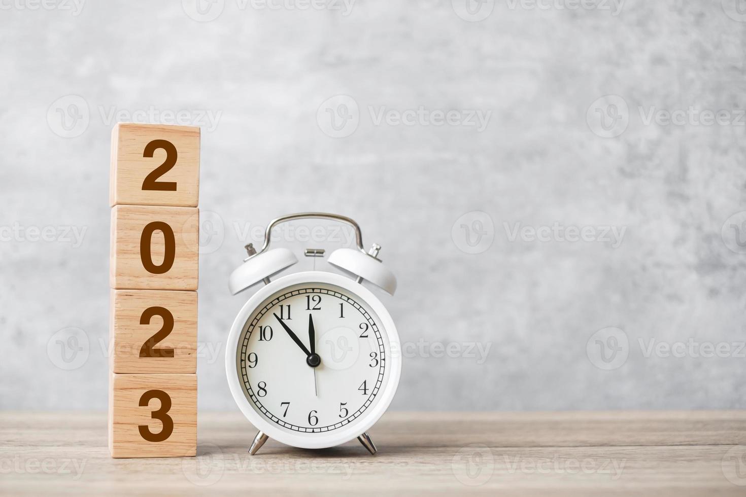 Happy New Year with vintage alarm clock and 2023 block. Christmas, New Start, Resolution, countdown, Goals, Plan, Action and Motivation Concept photo