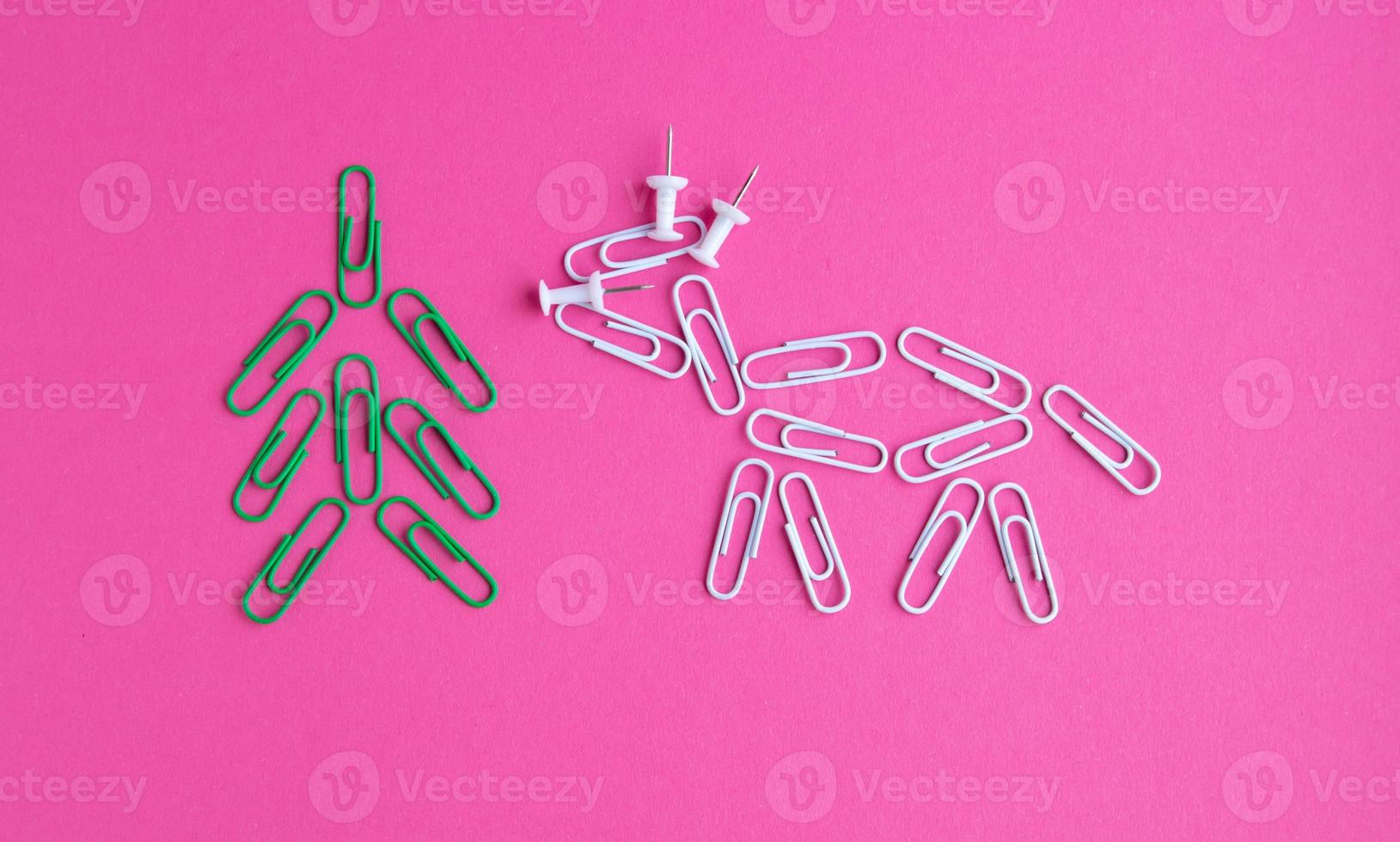 Year of the bull 2021.Colorful paper clips isolated on a pink background. Office supplies. Stapling documents and paper with paper clips. photo