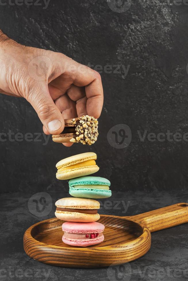 Macaroons stacked on a dark background. Delicious French cuisine photo