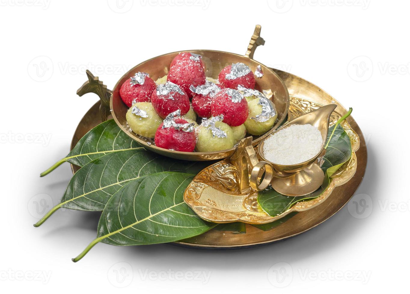 Besan Laddoo - Roasted gram flour mixed with Desi Ghee and sugar to make tasty and round shape sweet Laddu.Served in a Gold or Copper Plate. photo