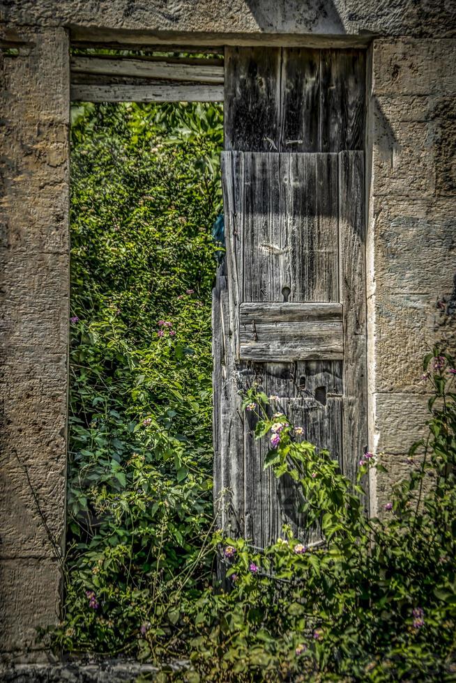 Old door on an abandoned building in Assos, Kefalonia photo