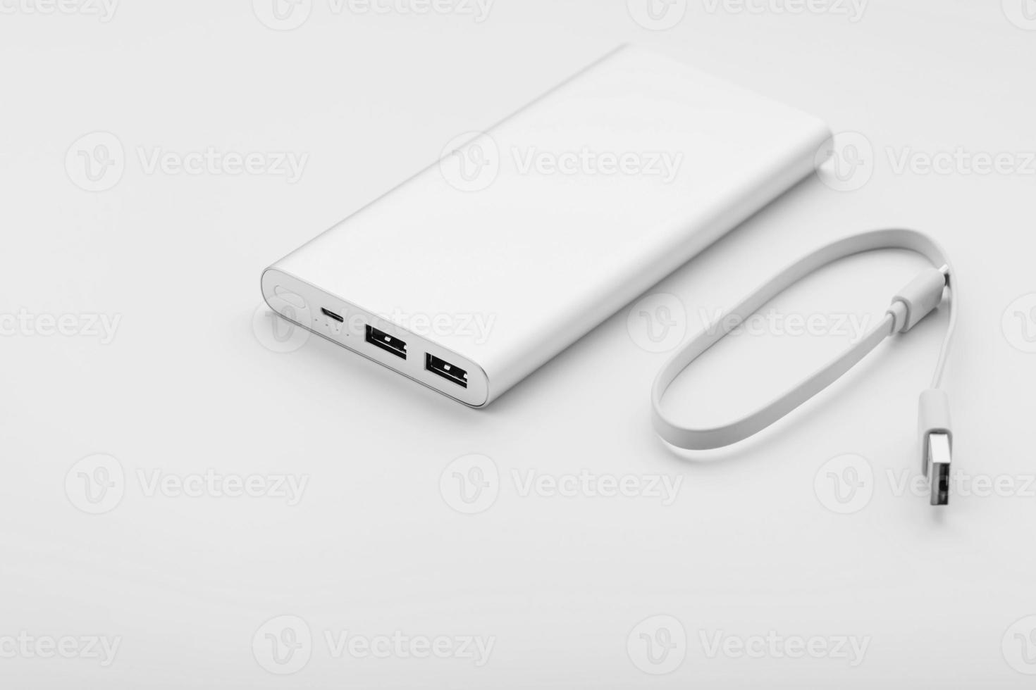 Powerbank for charging mobile devices with cable, on a white background. photo