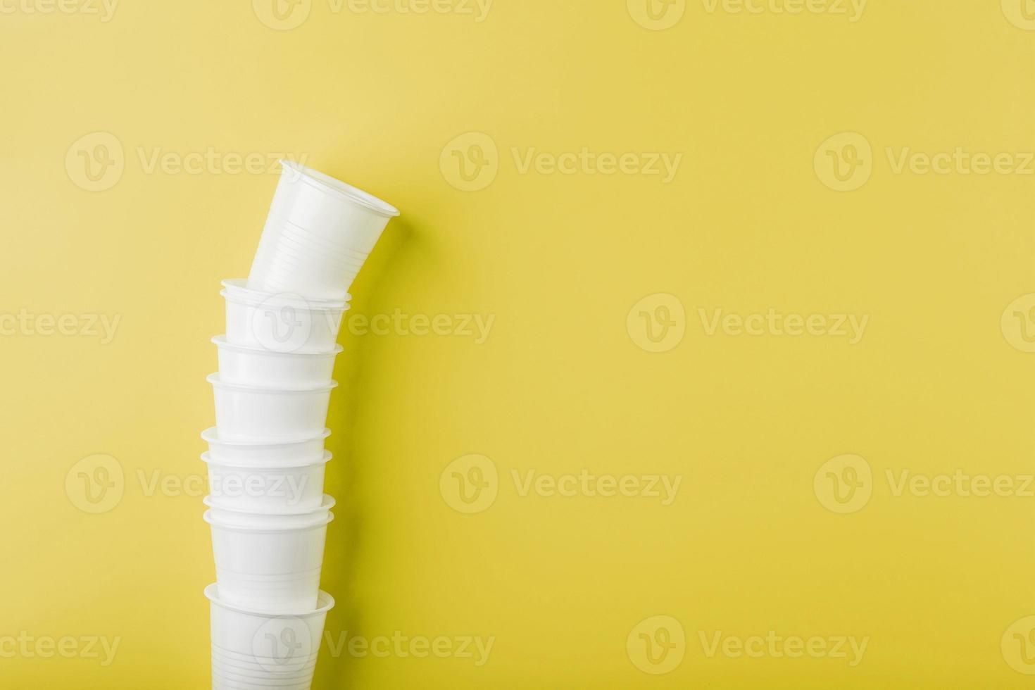 Plastic tableware on a yellow background with free space. photo