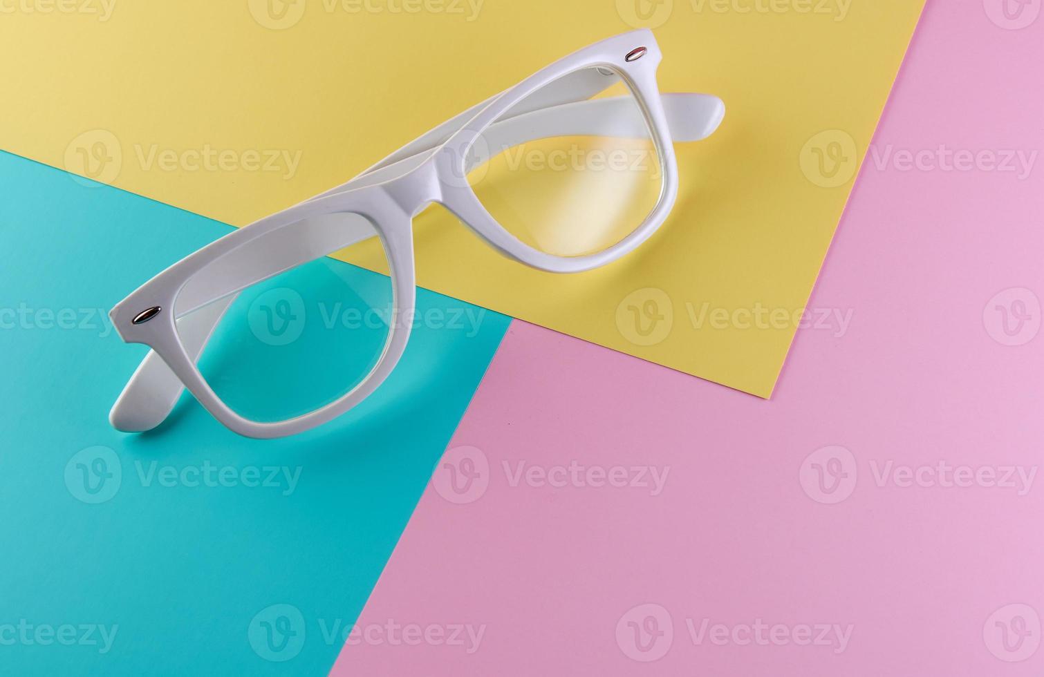 White glasses on a color background, top view. Trendy minimal style with colorful paper backdrop photo