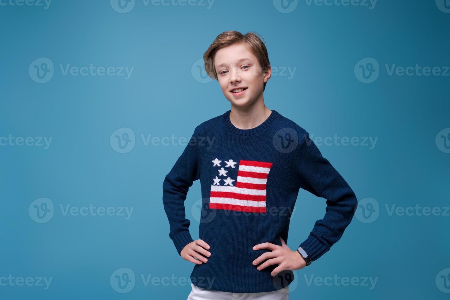 Portrait positive european guy, in blue sweater with usa flag, cheerful bright photo