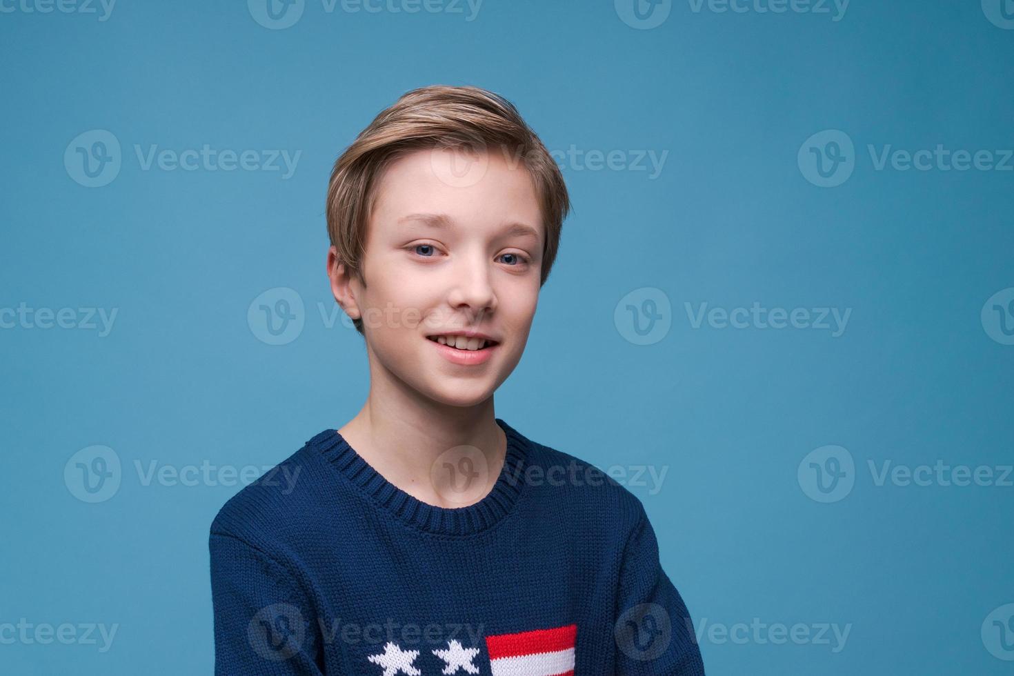 Happy relaxed contented handsome young man standing in blue sweater with usa photo