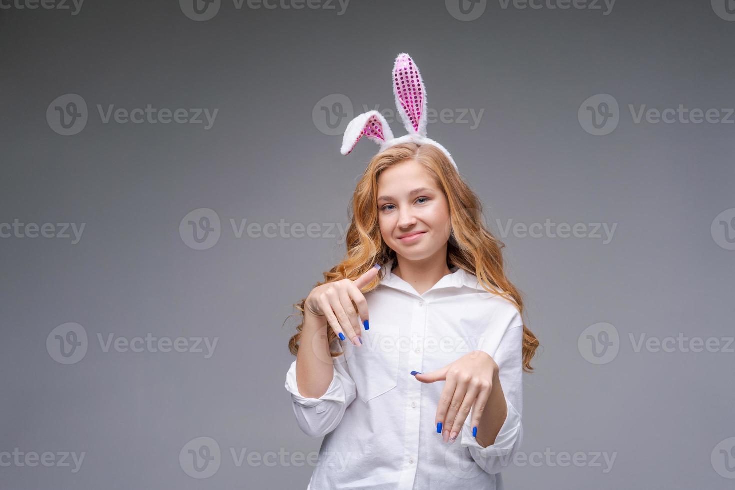 Cute beautiful girl wearing cute pink easter bunny ears, with impatience photo