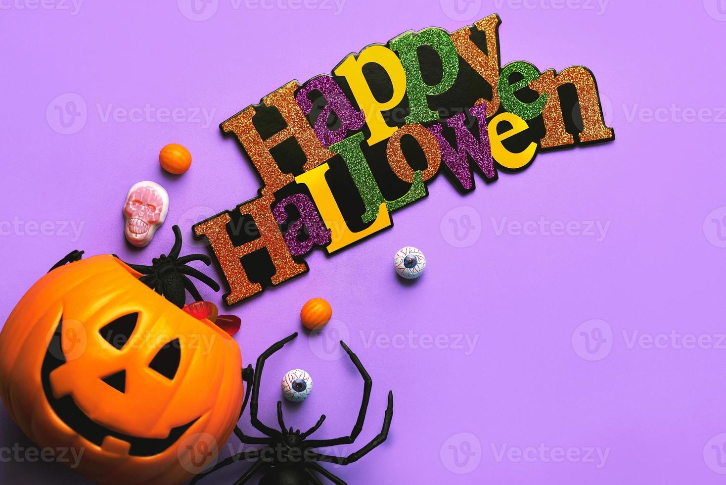 Happy Halloween. Top view of Halloween pumpkin basket full of candies and decoration Halloween party. Halloween concept background photo