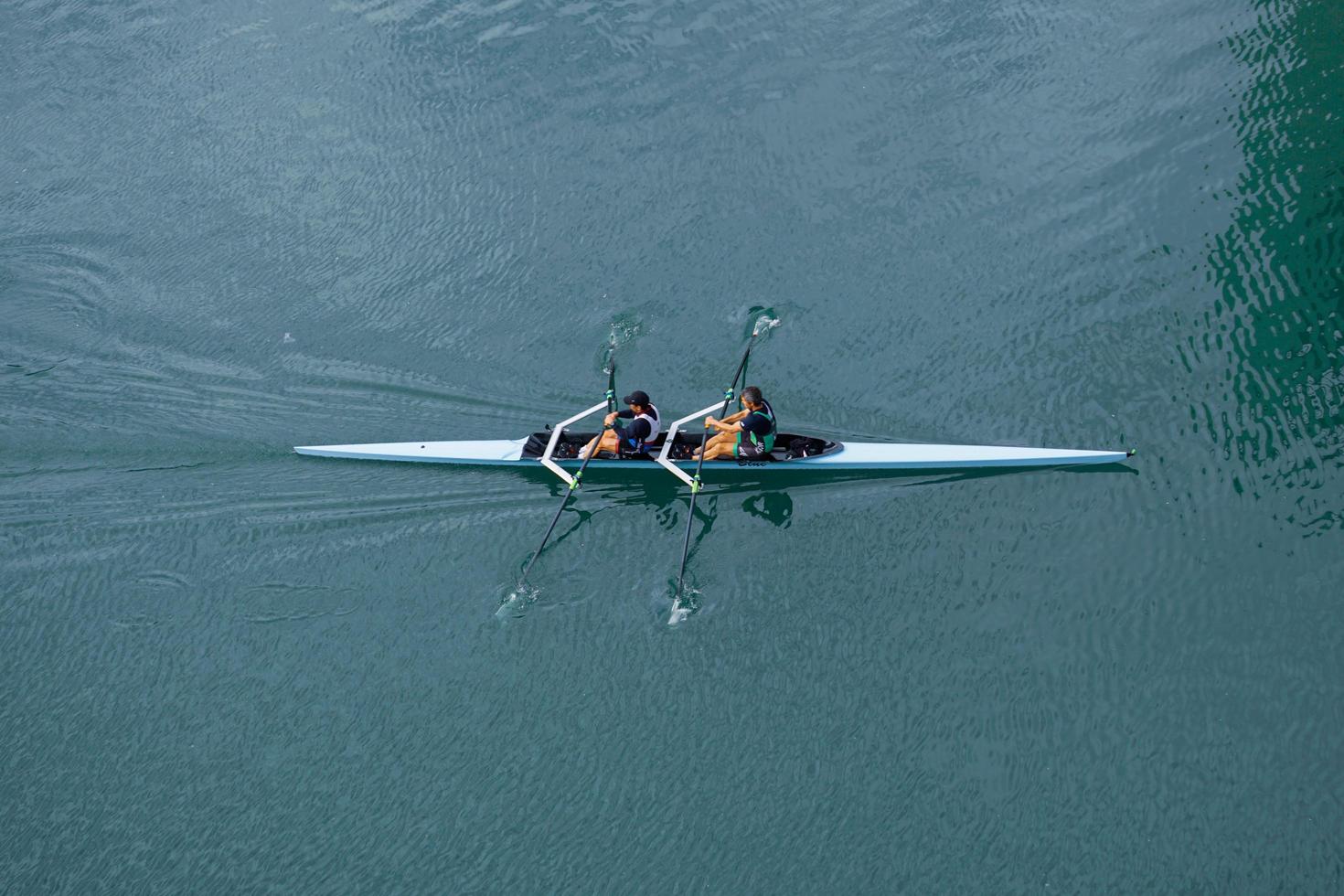 Bilbao, Vizcaya, Spain, 2022 - athletes training in canoe on the Nervion river in Bilbao city, photo