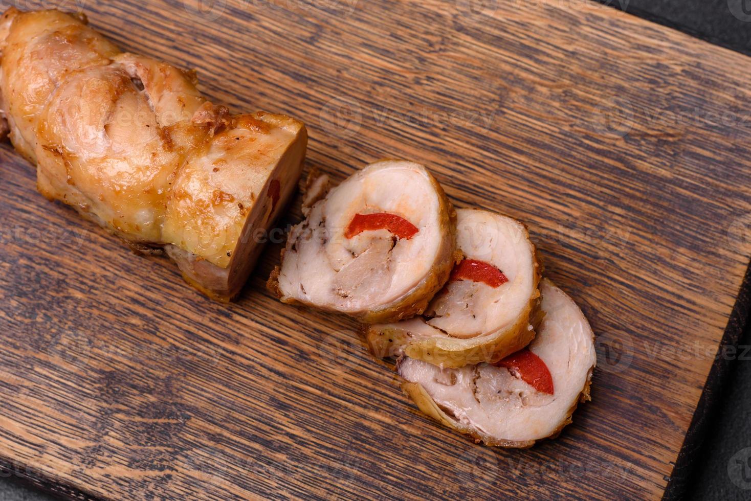 Tasty baked meat roll of chicken meat, sweet pepper with spices and herbs photo