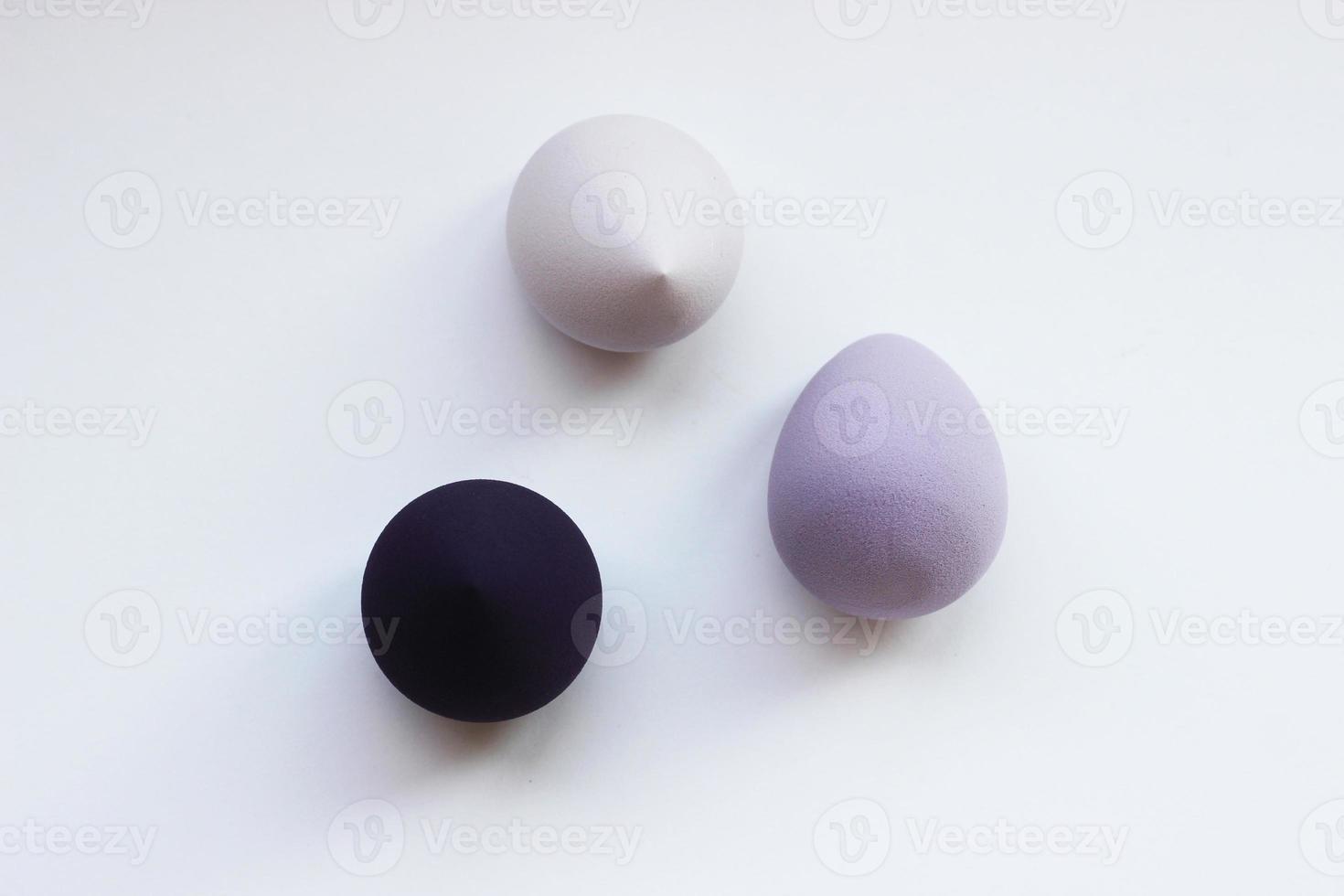 Different color cosmetic sponges on light background, horizontal photo. Beauty blenders for makeup, closeup fashion objects, tool for foundation cream photo