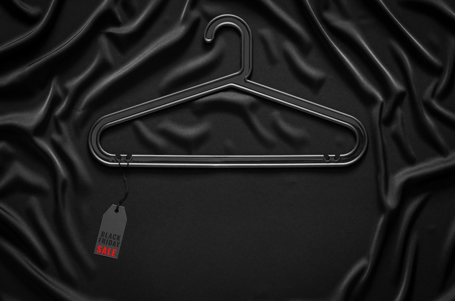 Black hanger that have price tag with word on black cloth background. Black Friday concept. photo