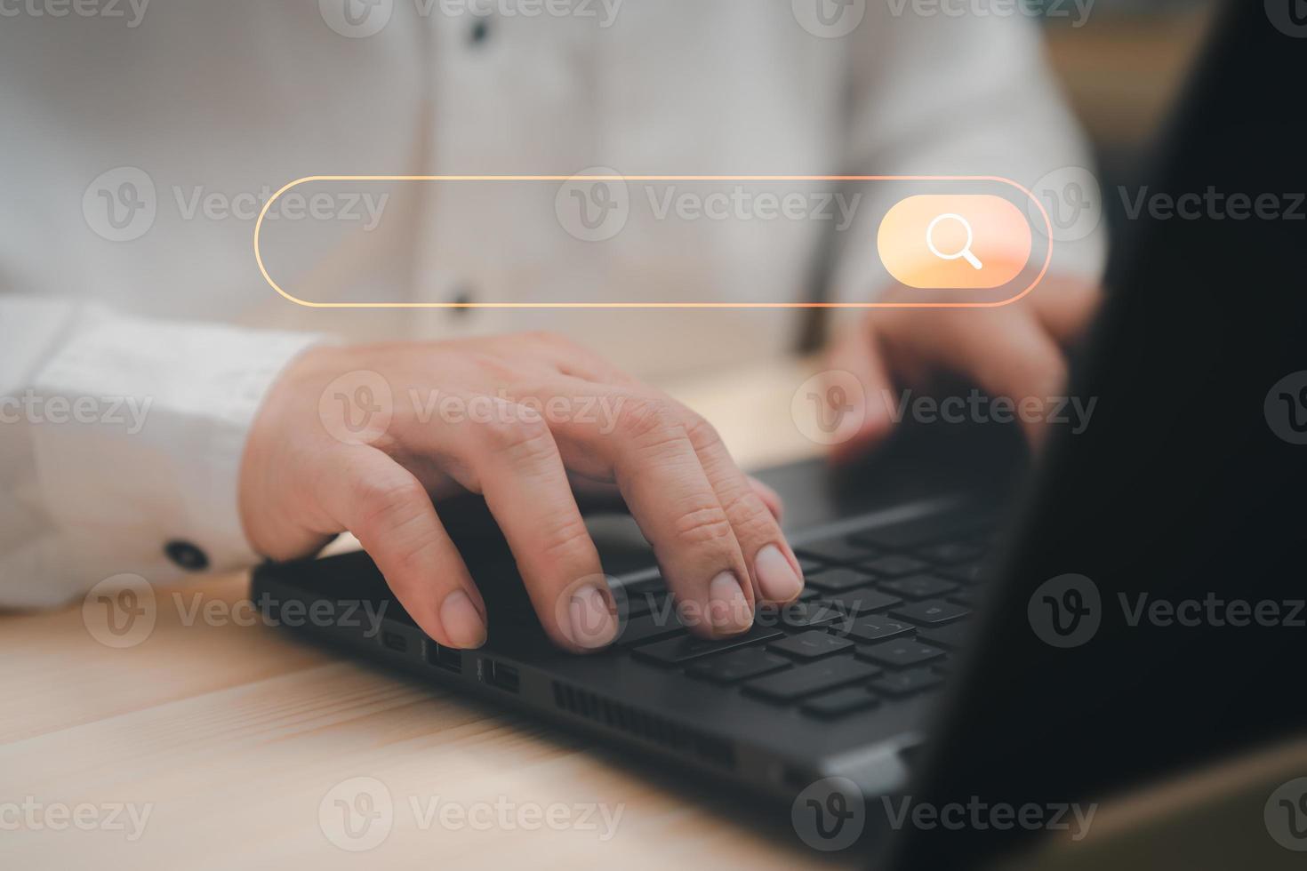 Freelance's hand working with computer laptop on desk in home. Searching Browsing Internet Data Information with blank search bar. Search Engine Optimization SEO Networking Concept. photo