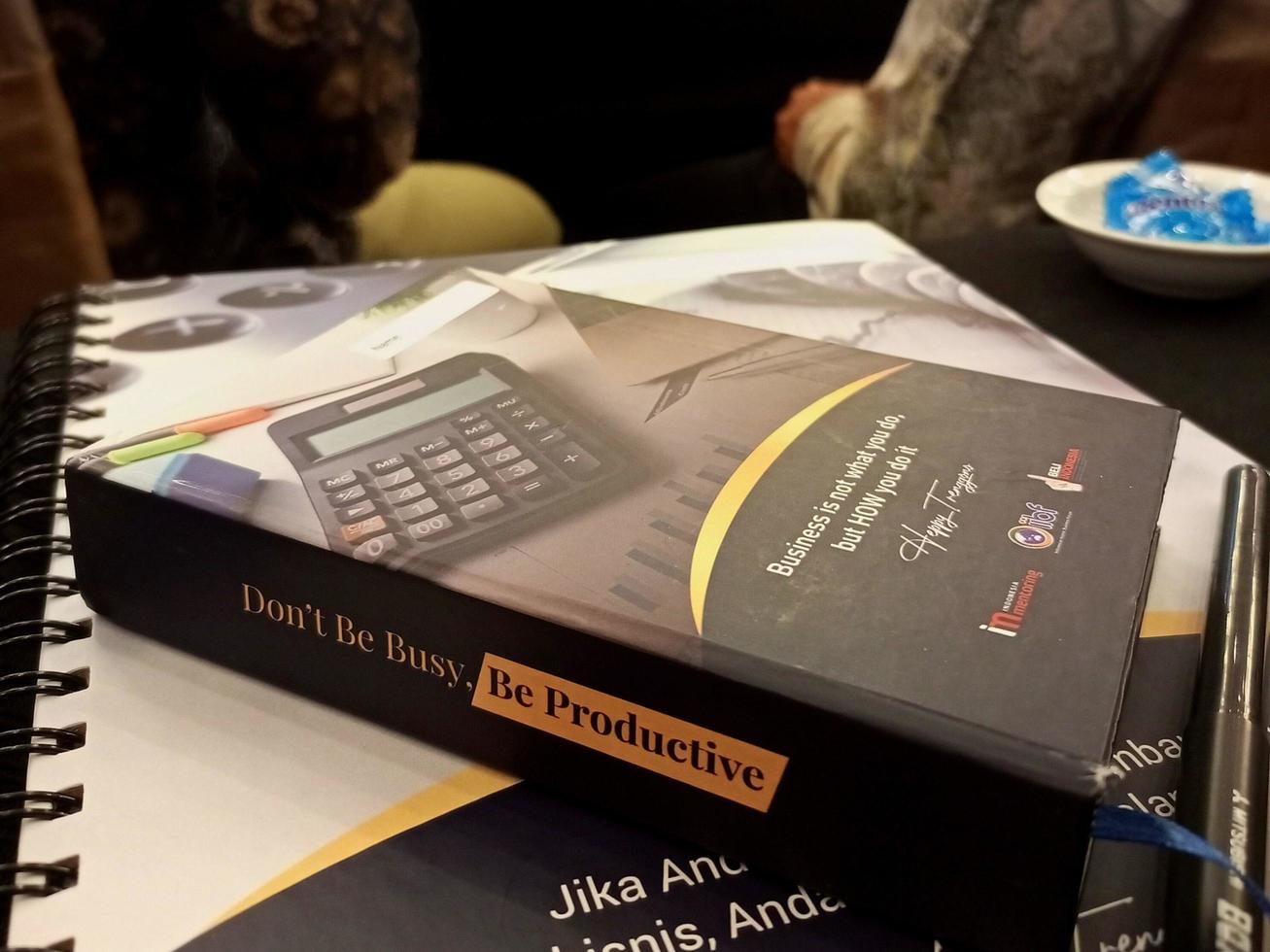 Jakarta, Indonesia, 2022 - Books and pens on a table in a workshop room photo