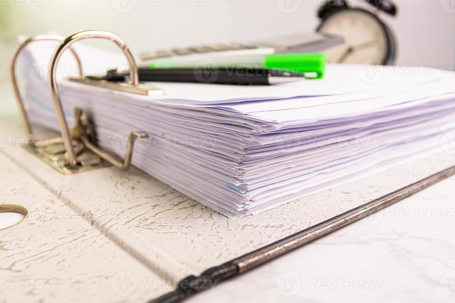 white paper stack in folder file for a business contract, income, expenses photo