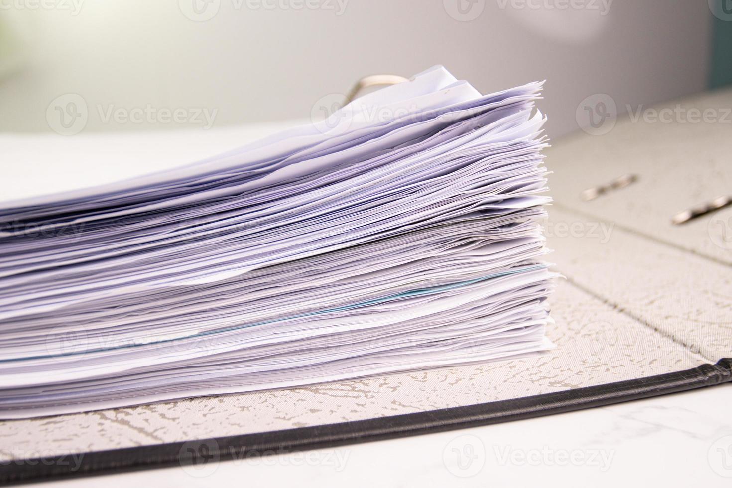 white paper stack in folder file for a business contract, income, expenses photo