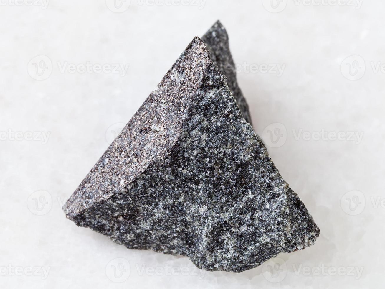 rough olivinite stone on white photo