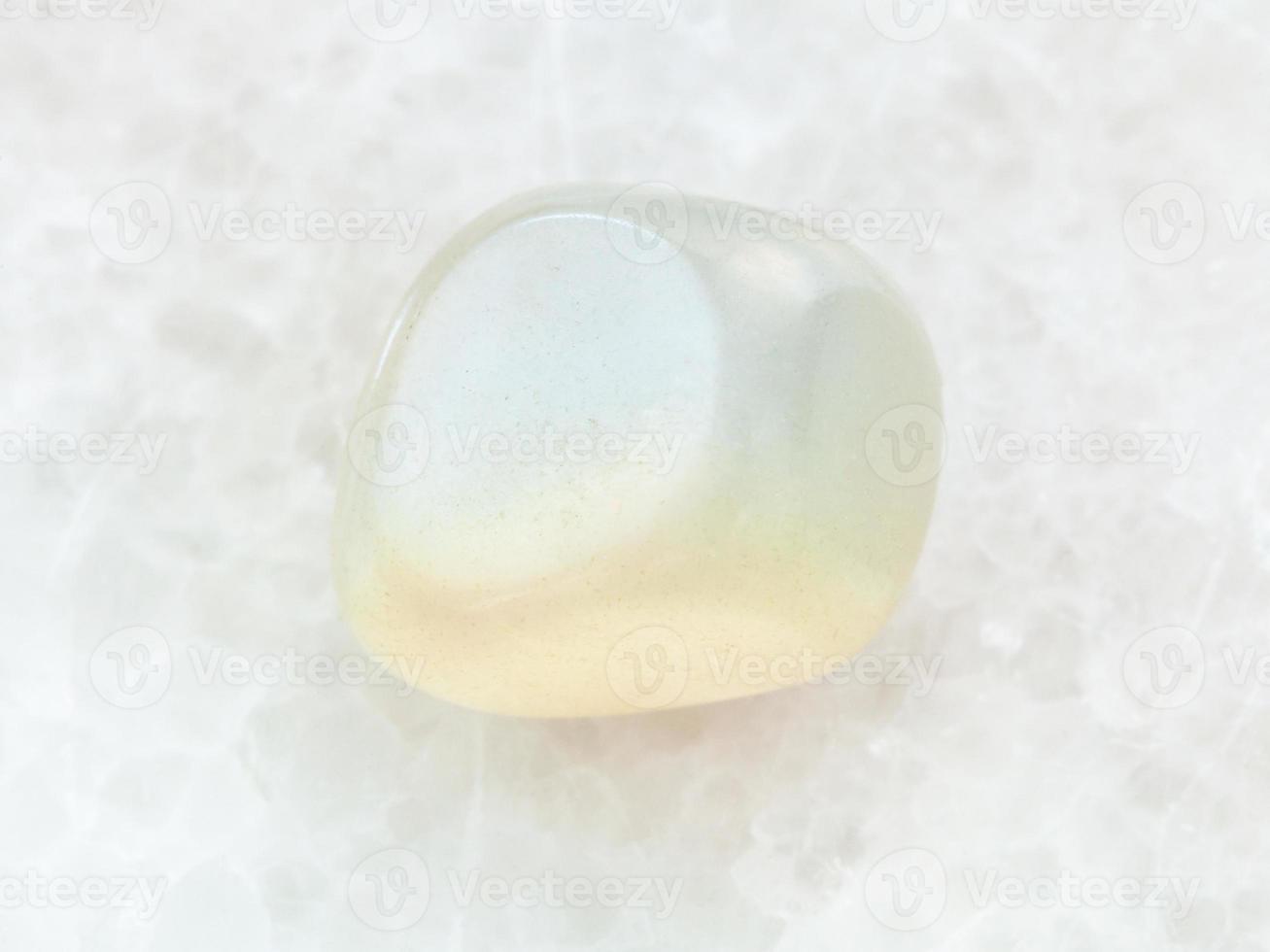 polished translucent moonstone gem stone on white photo
